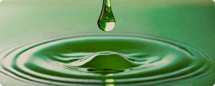 macro shot of a green drip single drop